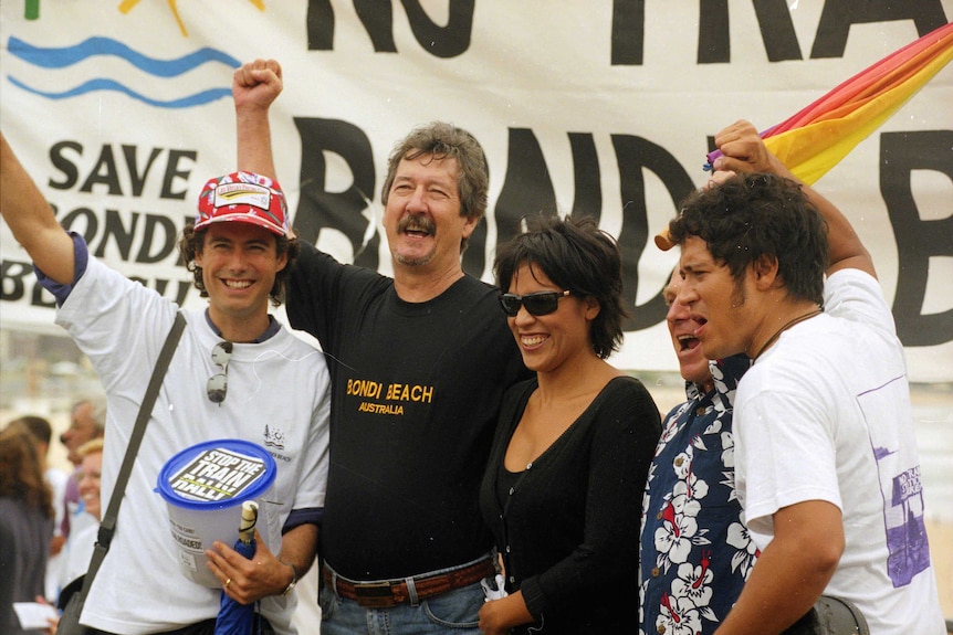 Actor Michael Caton [centre] at a Bondi train protest in Bondi.