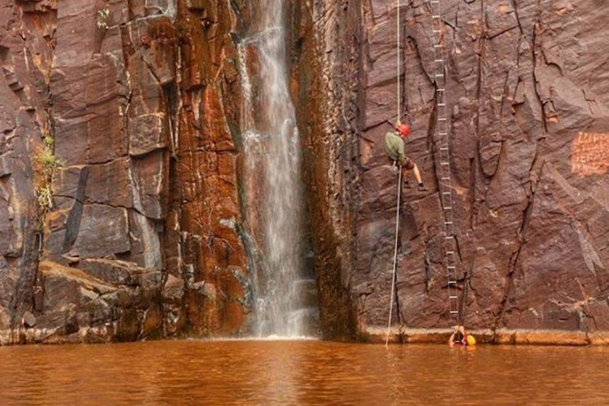 Defence Force people abseil into a full Python Pool.