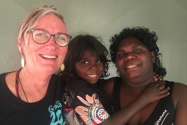 Leanne poses with yolngu woman and girl at Garma Festival
