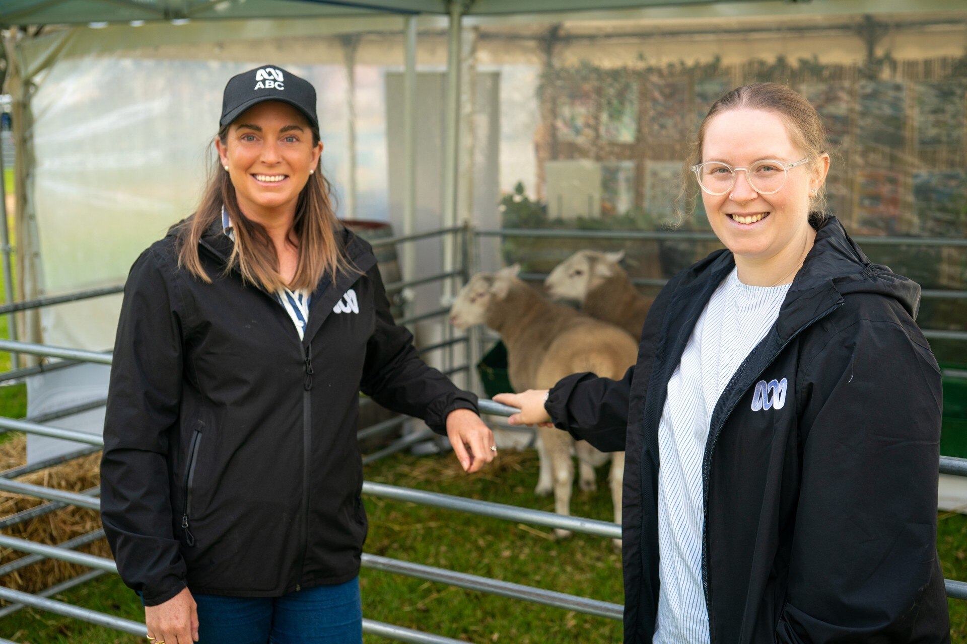 Two women in black jackets at the field days.