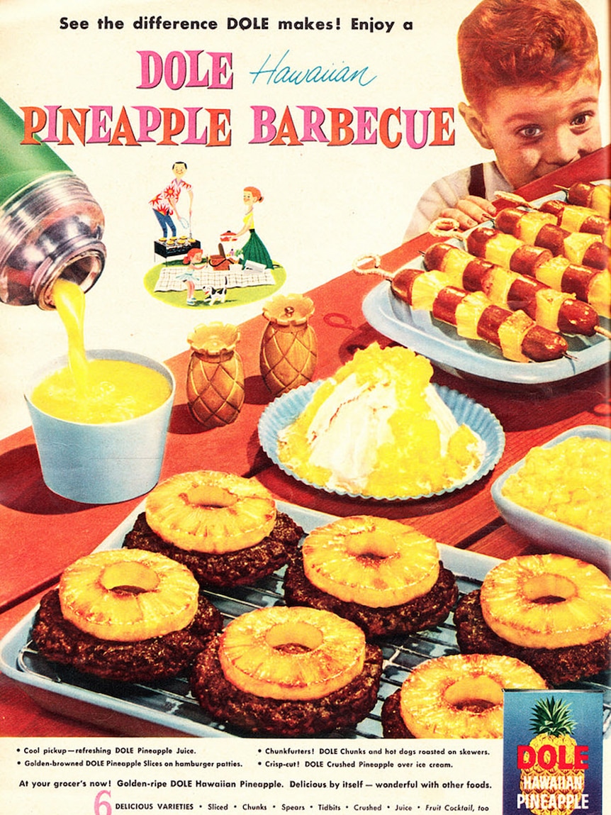Vintage photograph of a child with red hair looking at barbecued pineapple.