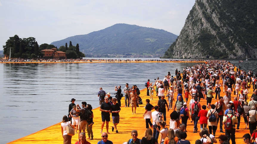 People 'walk on water' in a floating art installation by artist Christo in northern Italy.