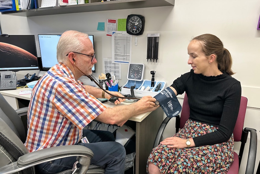 Dr Ewen McPhee takes the blood pressure of medical student Charlotte.