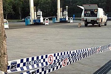 Police tape cordons off the scene at a service station at Park Ridge after a fatal stabbing.