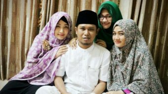 One of Indonesia's most well-known polygamists, Fadil Muzakki Syah, surrounded by his three wives, Siti, Yeni and Novita.