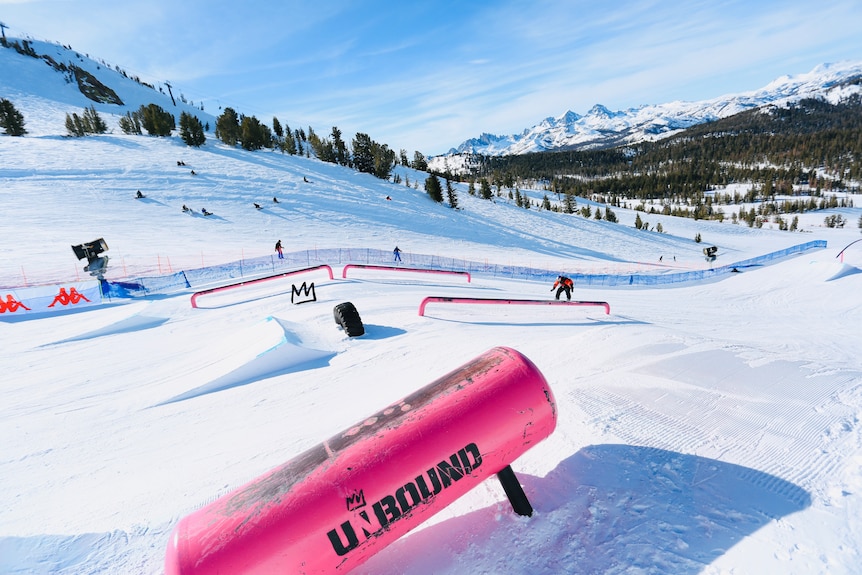 Val Guseli snowboards with mountains in the background