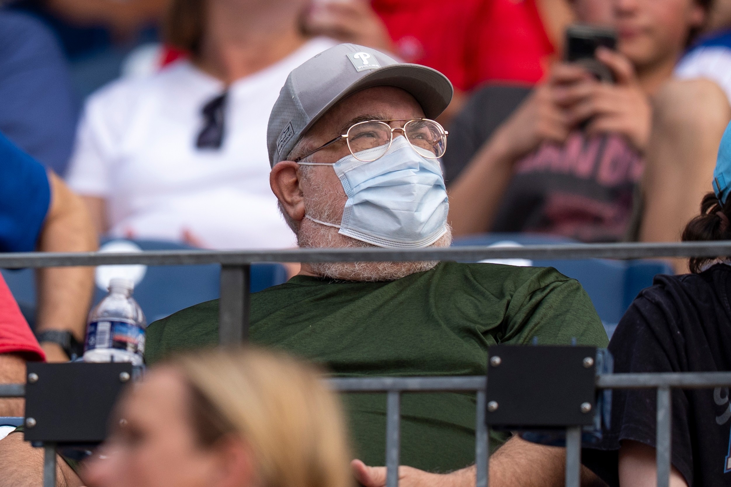 A baseball fan wears a medical mask in the stands.