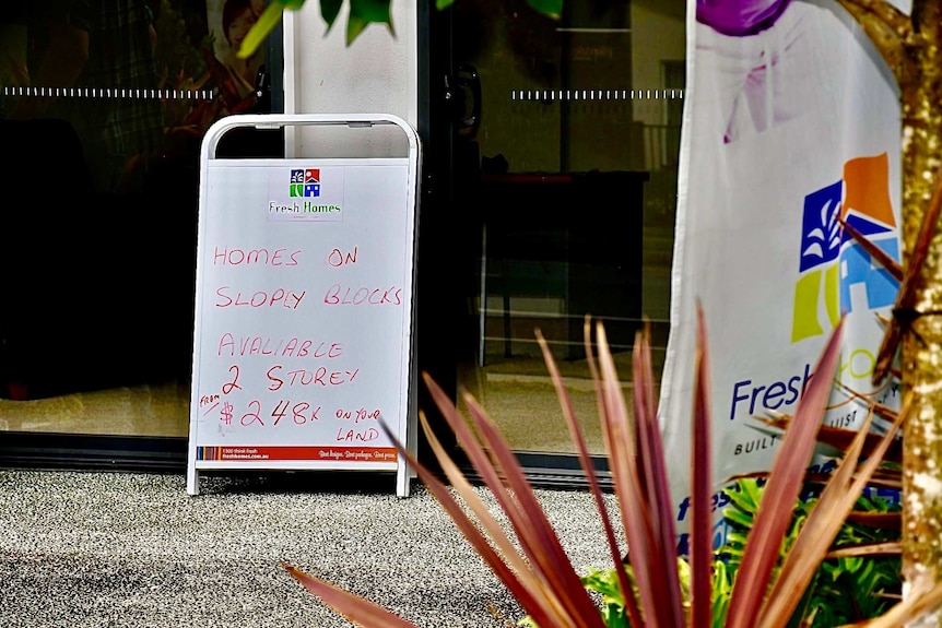 A sandwich board advertising a house and land package