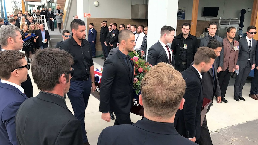 Fellow veterans form a guard of honour for Jesse's coffin