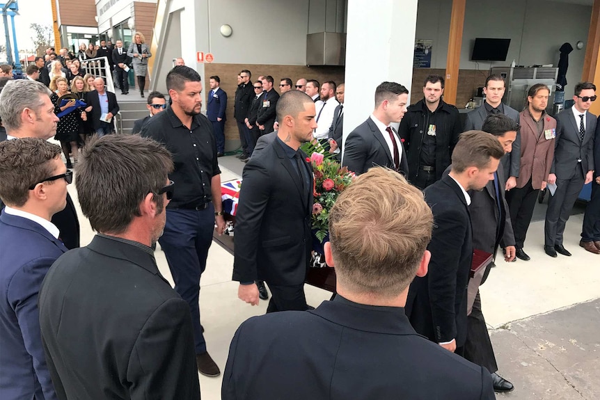 Fellow veterans form a guard of honour for Jesse's coffin