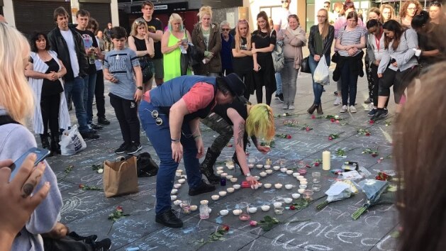 People gather to create a memorial for the Manchester attack