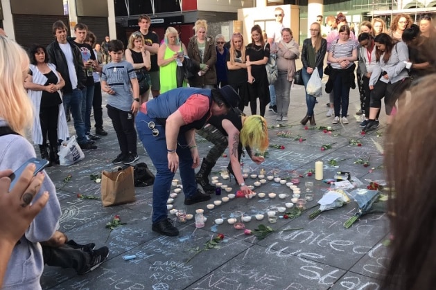 People gather to create a memorial for the Manchester attack