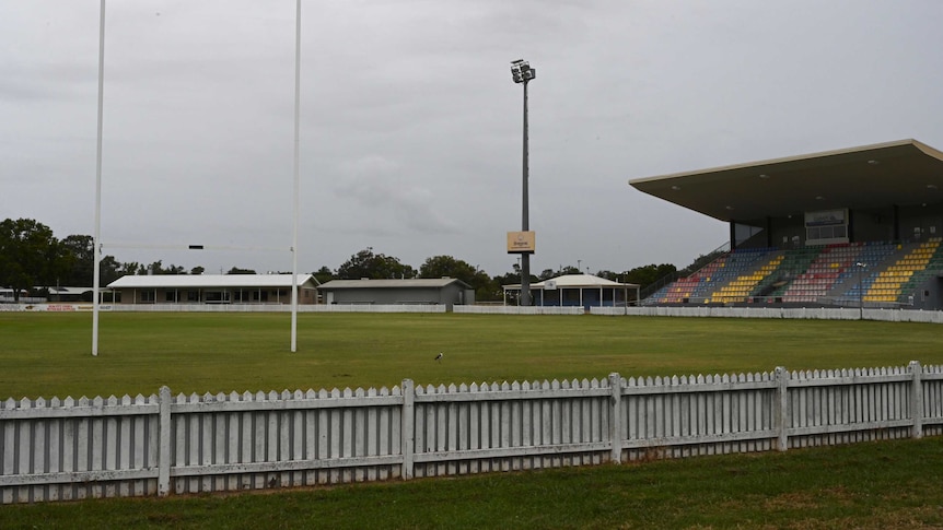 An empty stadium overlooks an empty field on a rainy day in Bundaberg.
