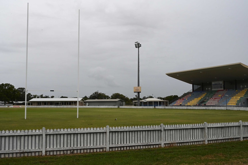 An empty stadium overlooks an empty field on a rainy day in Bundaberg.