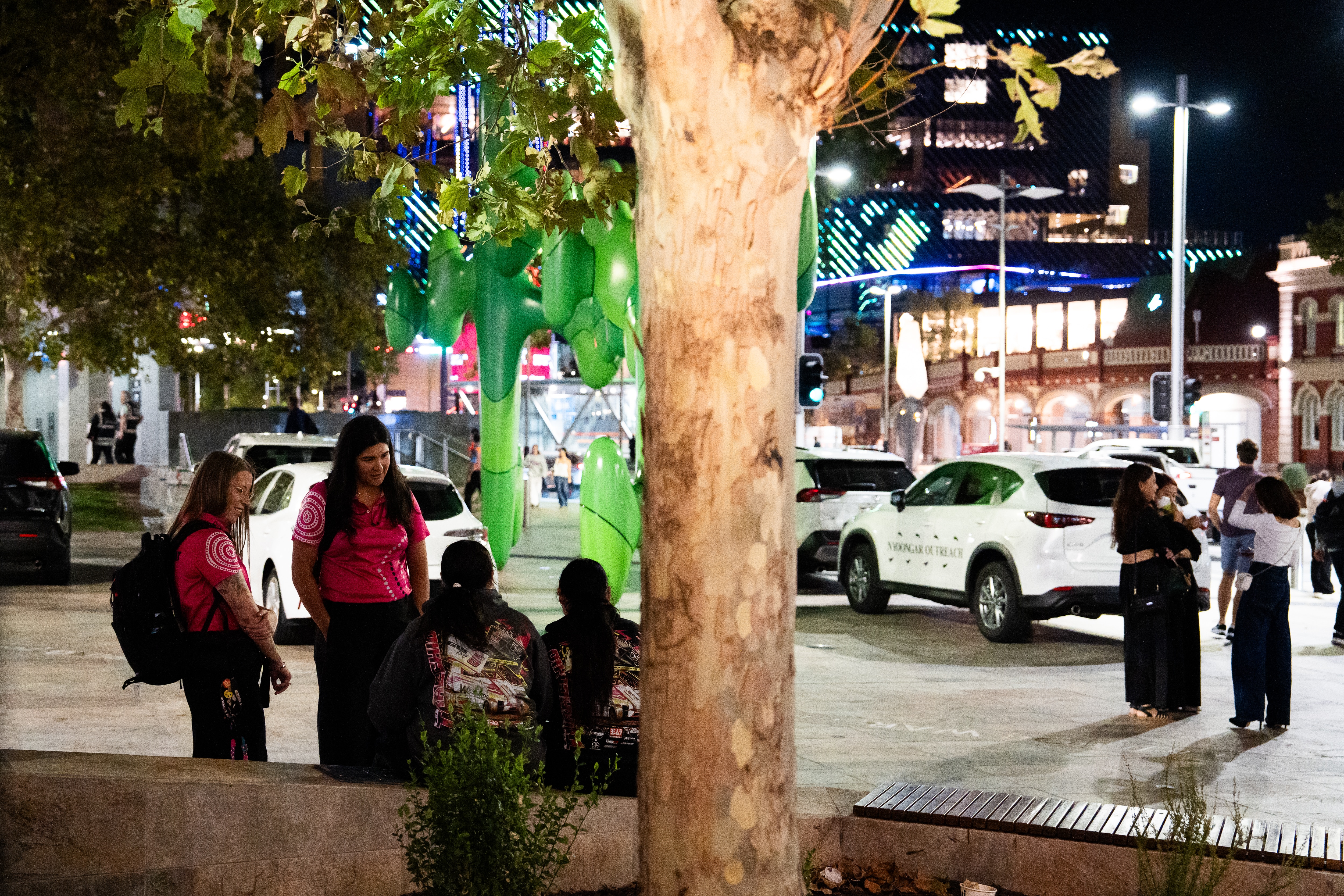 Two women who are youth workers speak to two young women in the streets of Perth