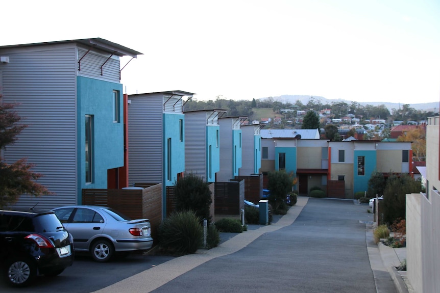 A development of blue and grey townhouses.