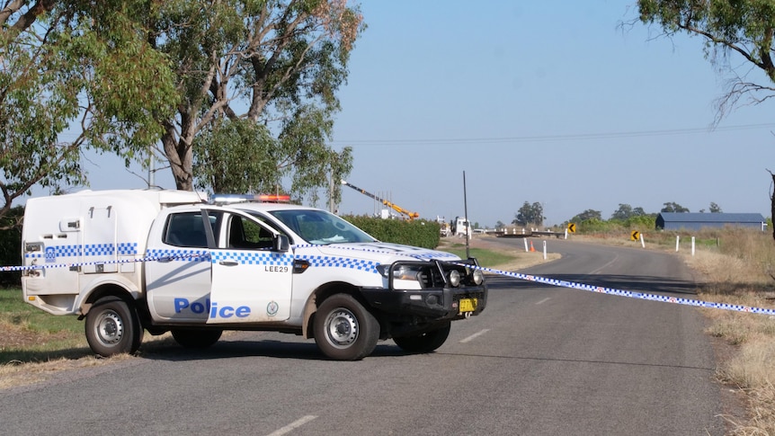 Police vehicle and tape block off a crime scene in Yanco, NSW