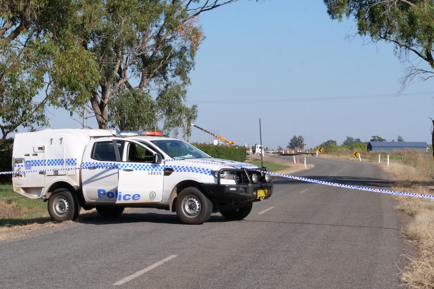Police vehicle and tape block off a crime scene in Yanco, NSW