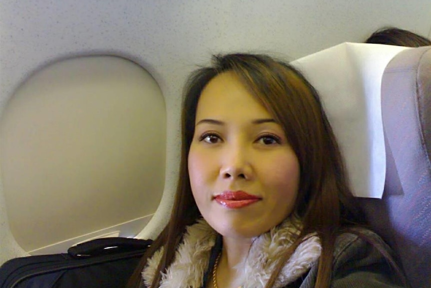 A Thai woman sitting on the plane