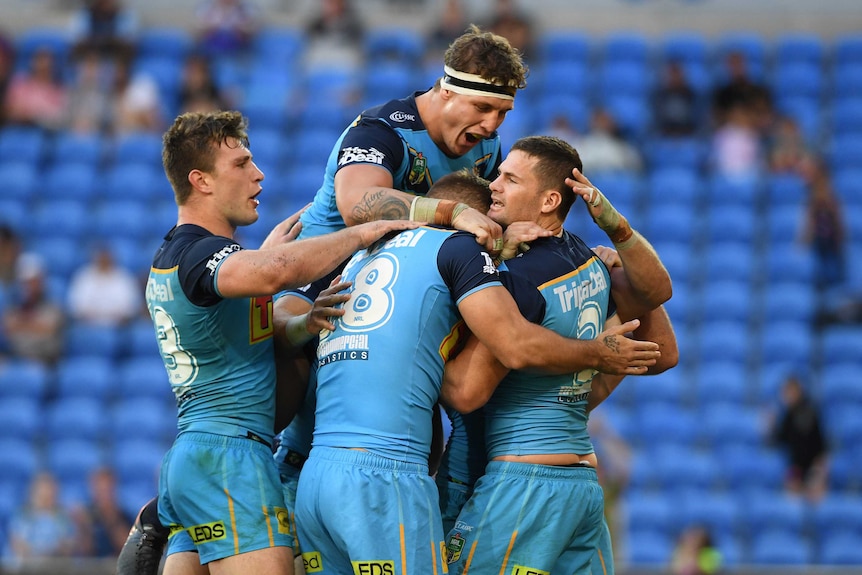 Titans players react following a try by Anthony Don during the Round 11 NRL match against Newcastle.