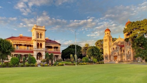 Two old buildings and lawn