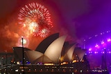 Fireworks explode near the Sydney Opera House as part of new year celebrations on Sydney Harbour