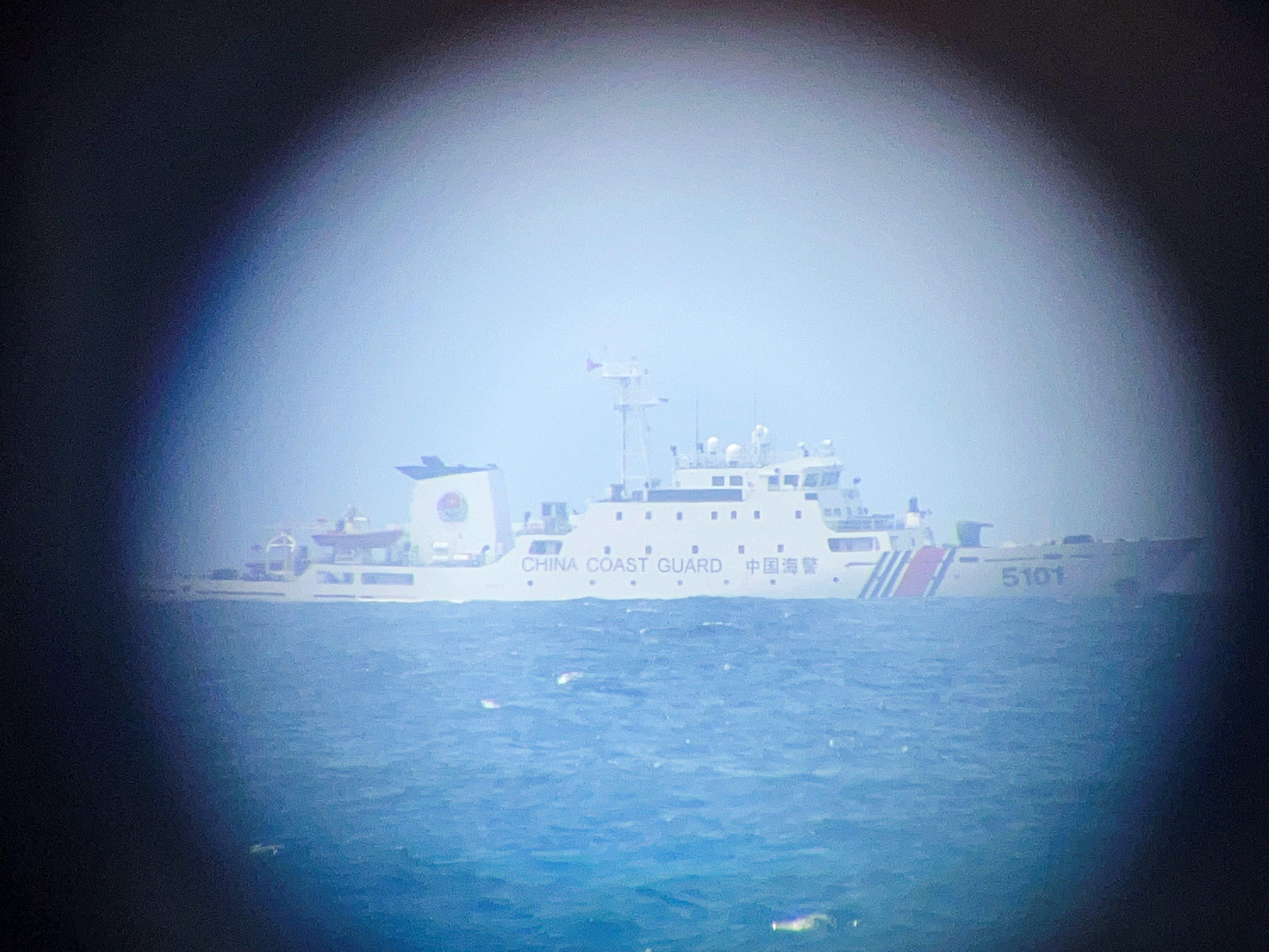 A zoomed in photo of a vessel with the markings 'China Coast Guard' on the hull.  