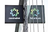 A sign of Centrelink mirrored in a window.