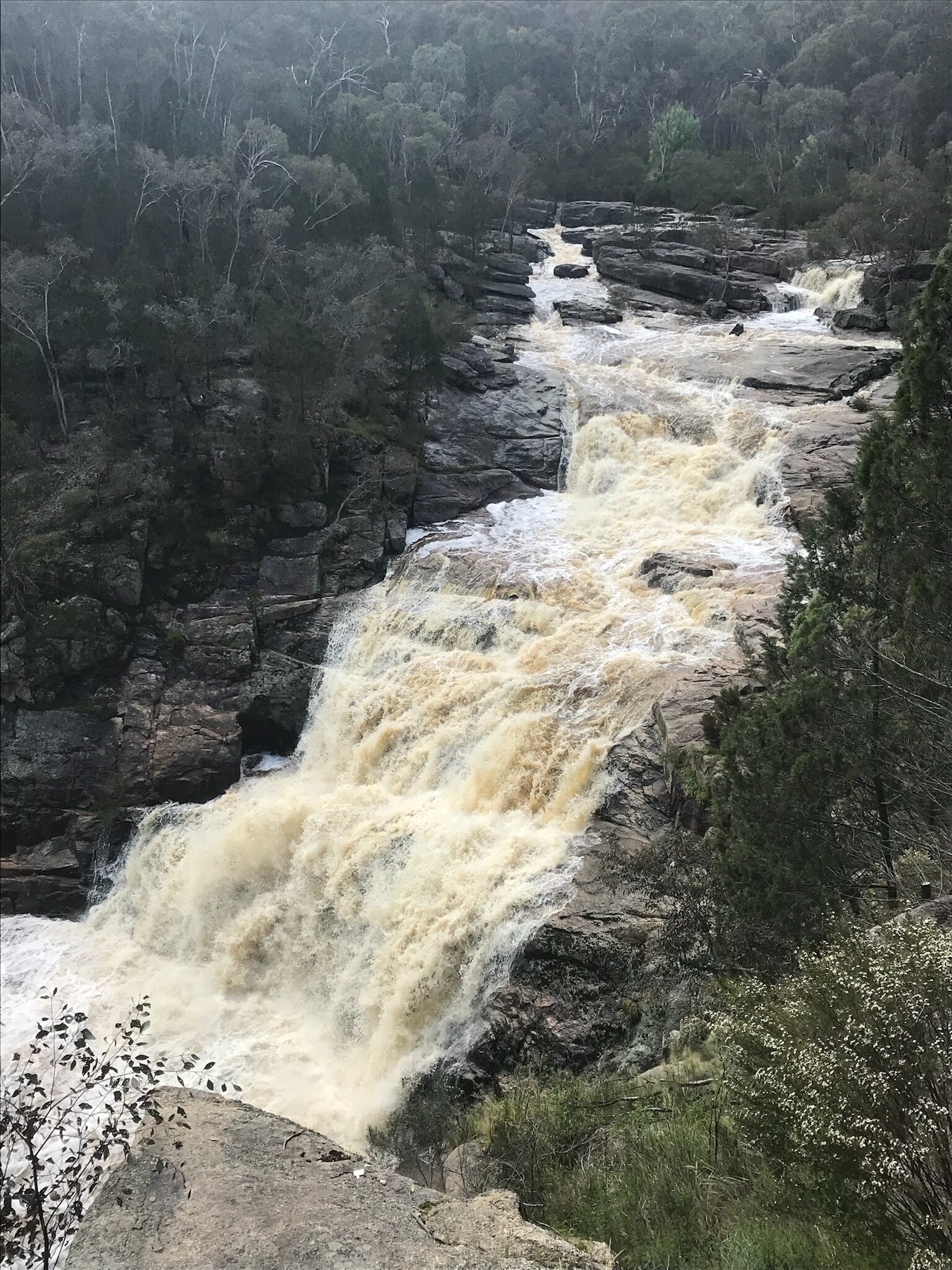 A multi level waterfall cascading down a rocky slope.
