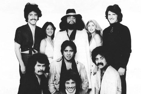 Lori Balmer in a black and white promotional image with the band members of Collison