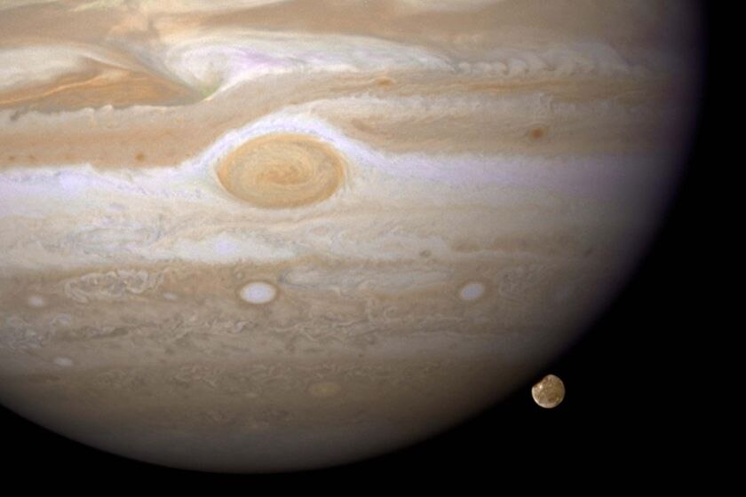 Jupiter's moon, Ganymede, sits behind the solar system's largest planet
