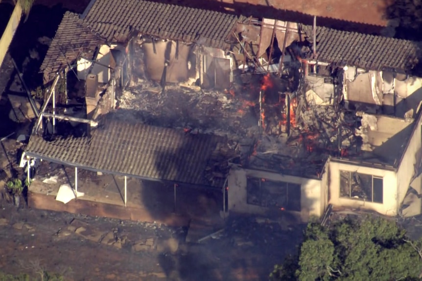 An aerial photo of a house gutted by flames