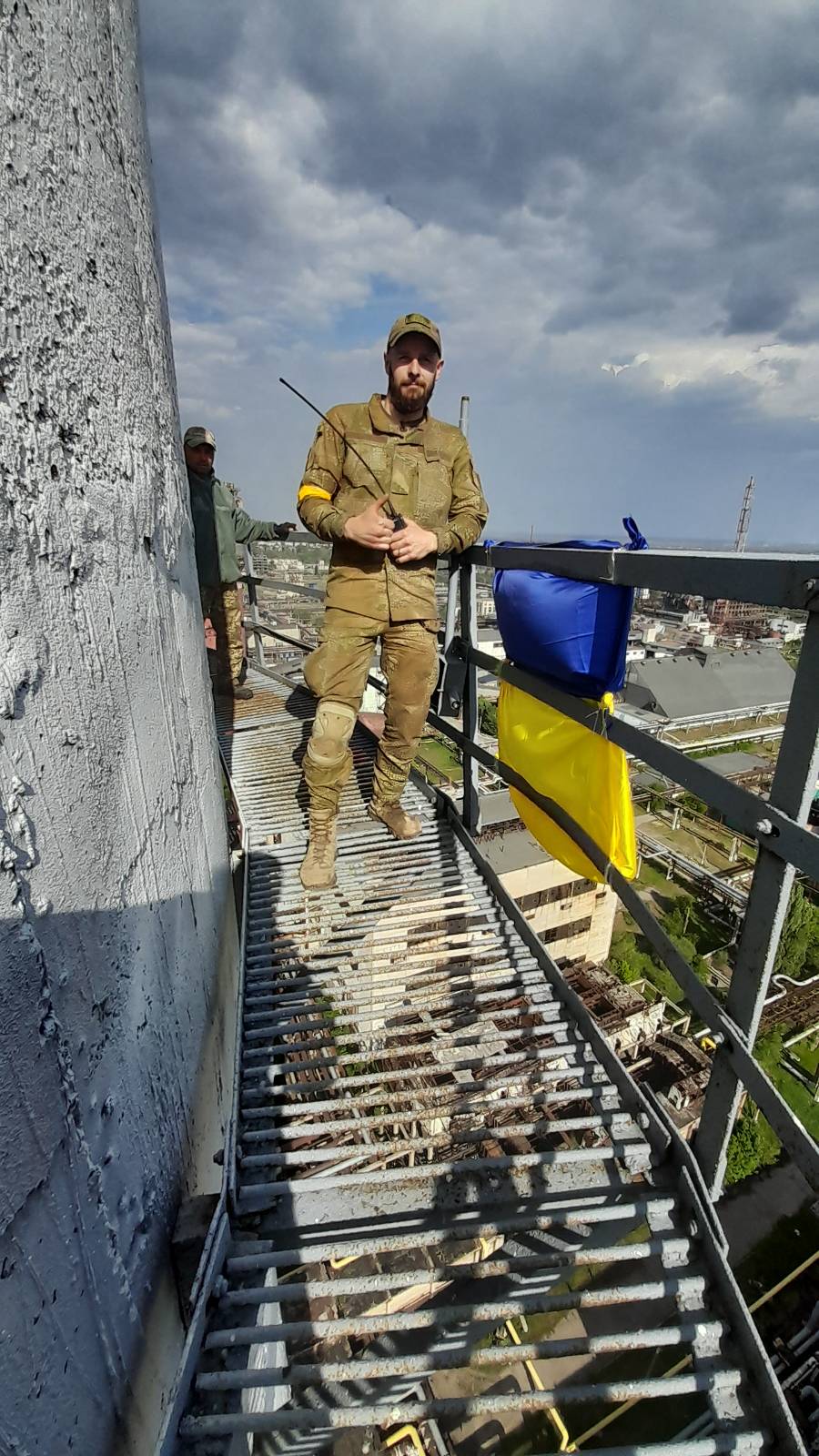 A soldier in uniform standing and looking at the camera. 