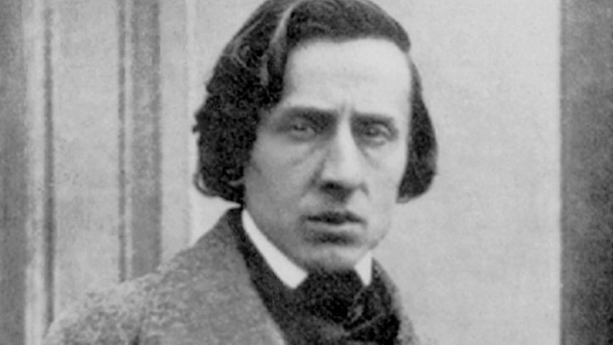 A black and white photo of Frederic Chopin head and shoulders with a wide-collared coat and bow-tie.