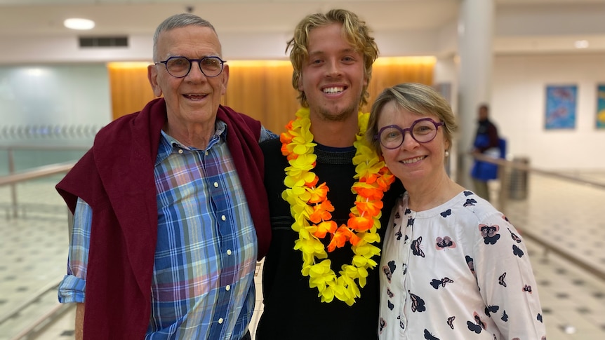 Tom Robinson with parents at Brisbane Airport