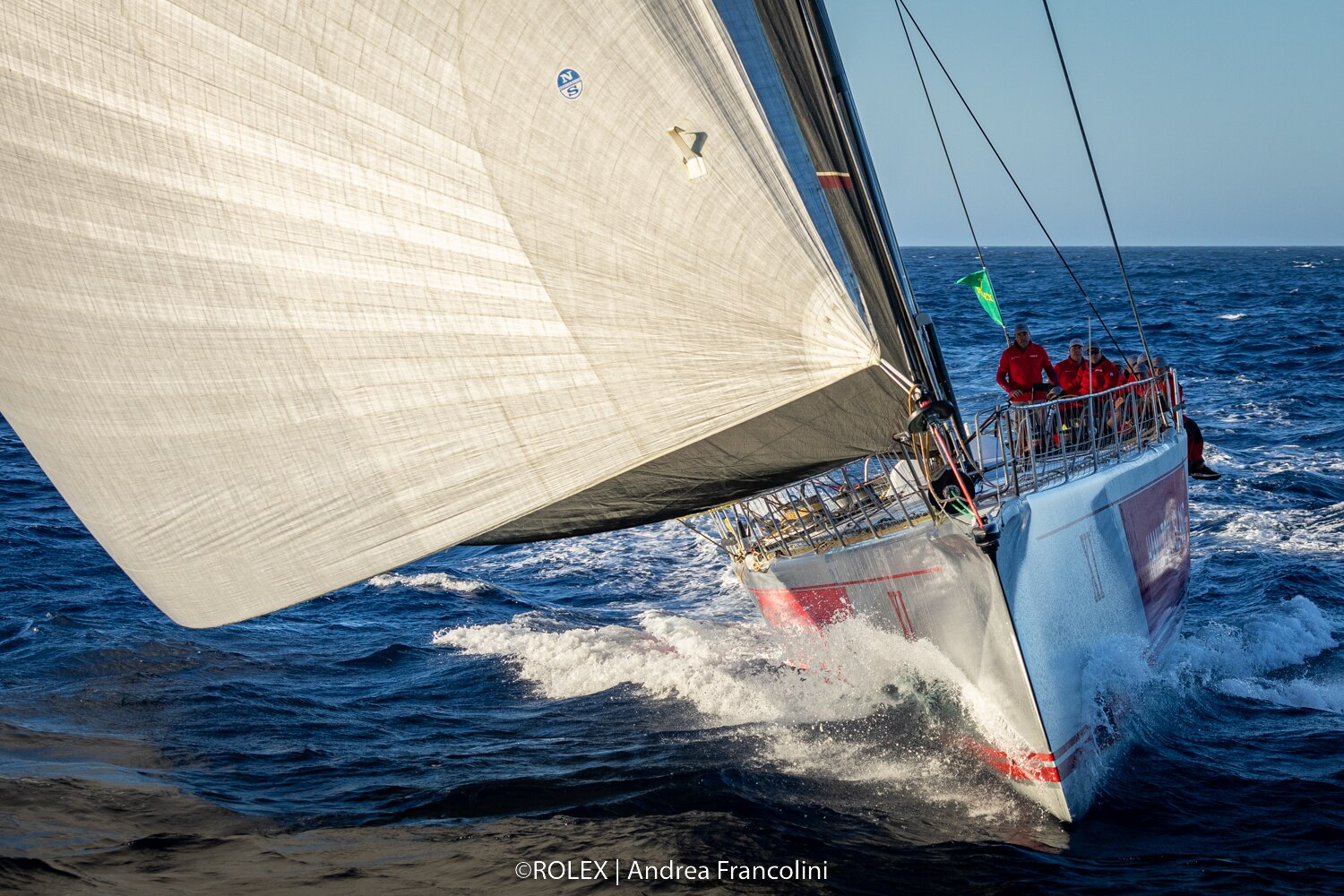 Large yacht sails directly towards the camera.