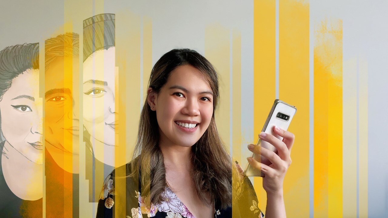 A woman holds her phone