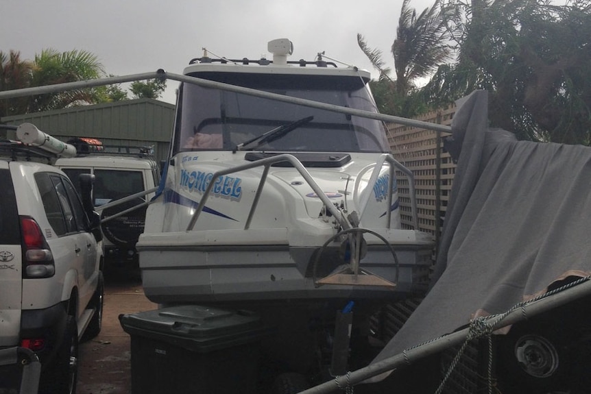 Carport blows onto Mick's boat in Exmouth as cyclone Quang approaches coast