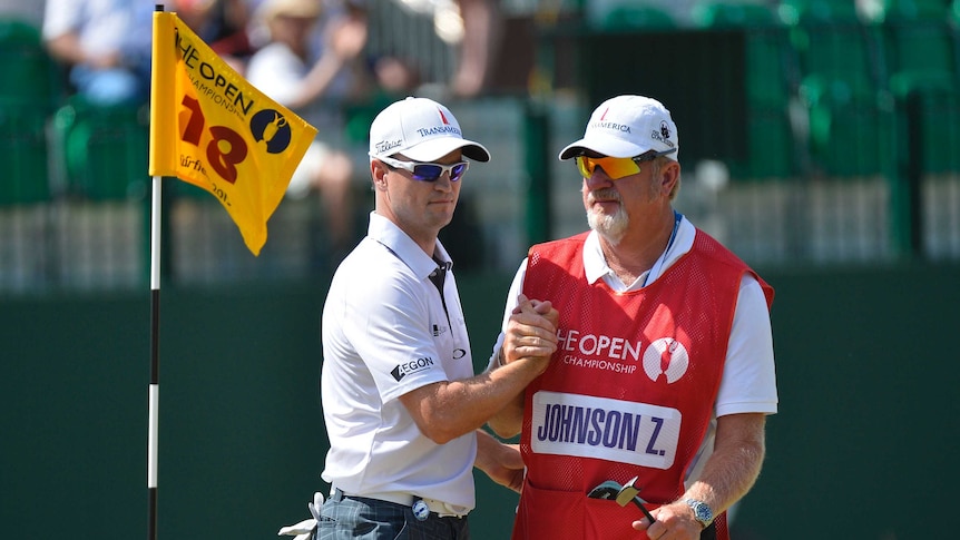 American Zach Johnson (left) shakes hands with his caddie Damon Green on the 18th green at Muirfield