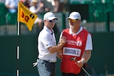 American Zach Johnson (left) shakes hands with his caddie Damon Green on the 18th green at Muirfield