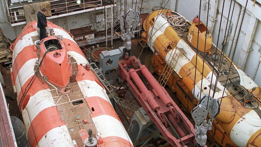 A Russian mini rescue submarine called a Priz, left, seen aboard a rescue ship.