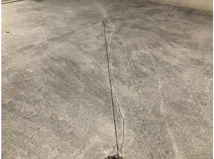 cracks on the floor of an apartment complex