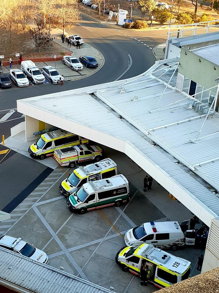 Police cars and ambulances outside the Canberra Hospital emergency department.