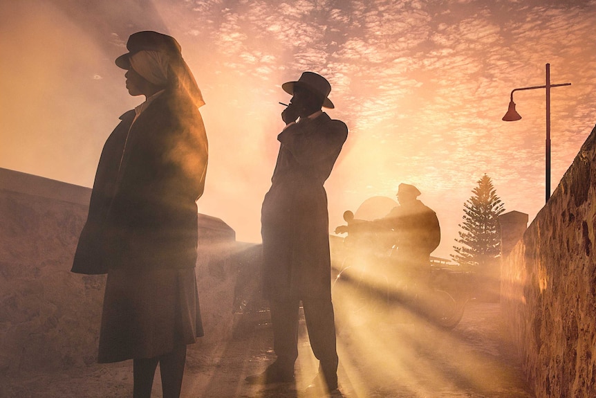 Gloss photo of individuals standing in sunlight.