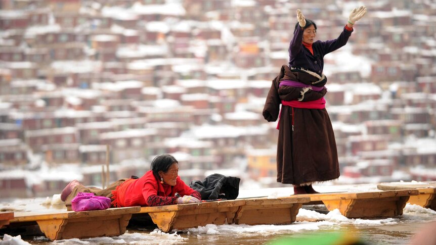 Tibetan pilgrims worship at Seda Monastery.