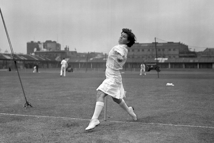 A black and white image of Betty Wilson about to bowl.