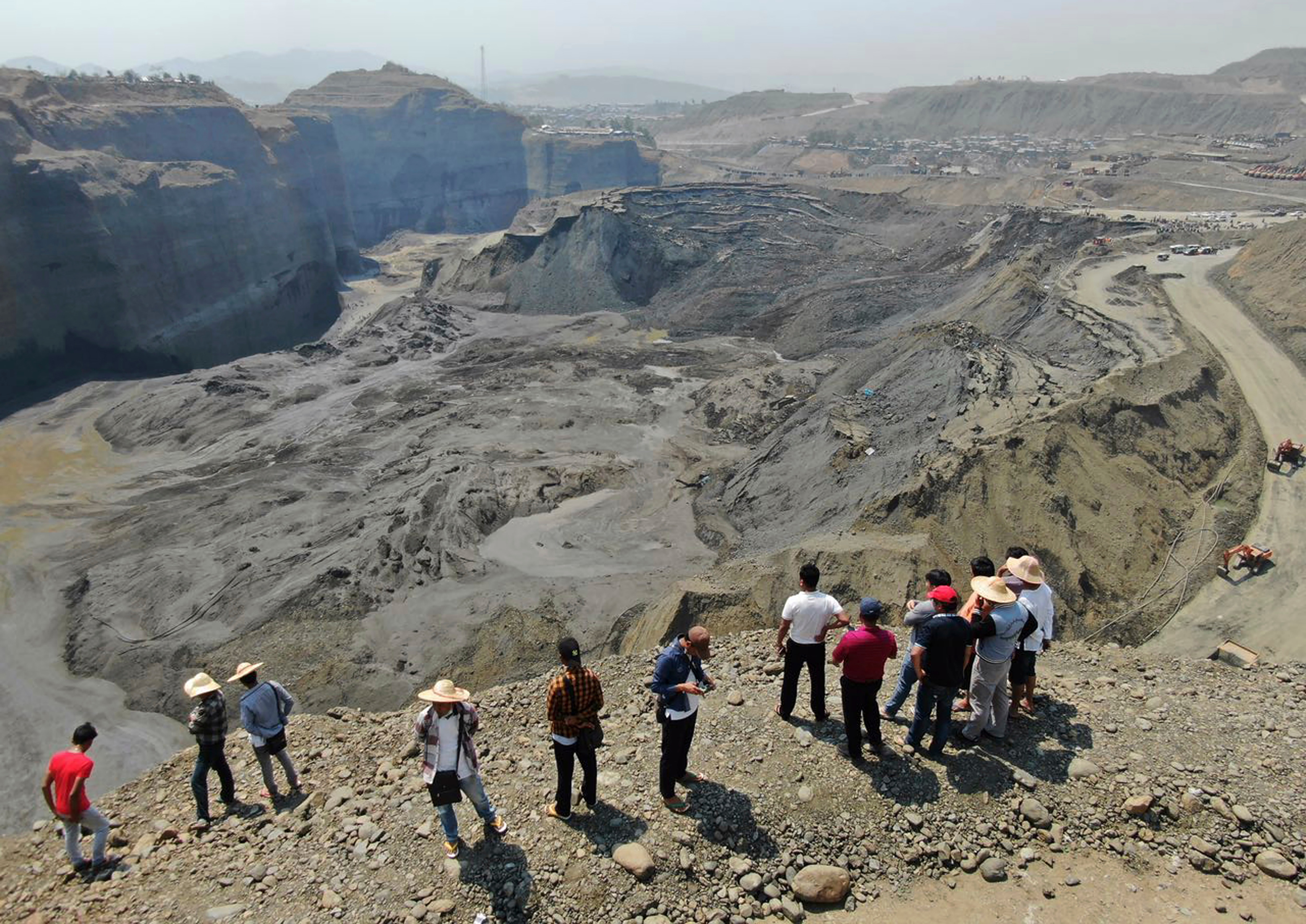 Onlookers observe a UN sanctioned mining site in Hpakant area of Kachin state, northern Myanmar