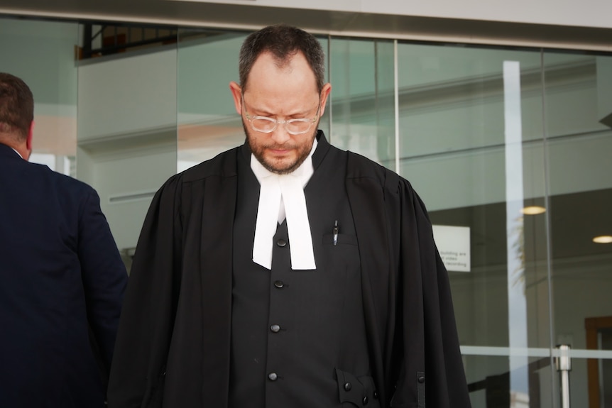 A man in a suit leaving a building