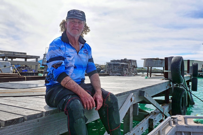 Abrolhos Islands aquaculture farmer Murray Davidson sits on jetty. 