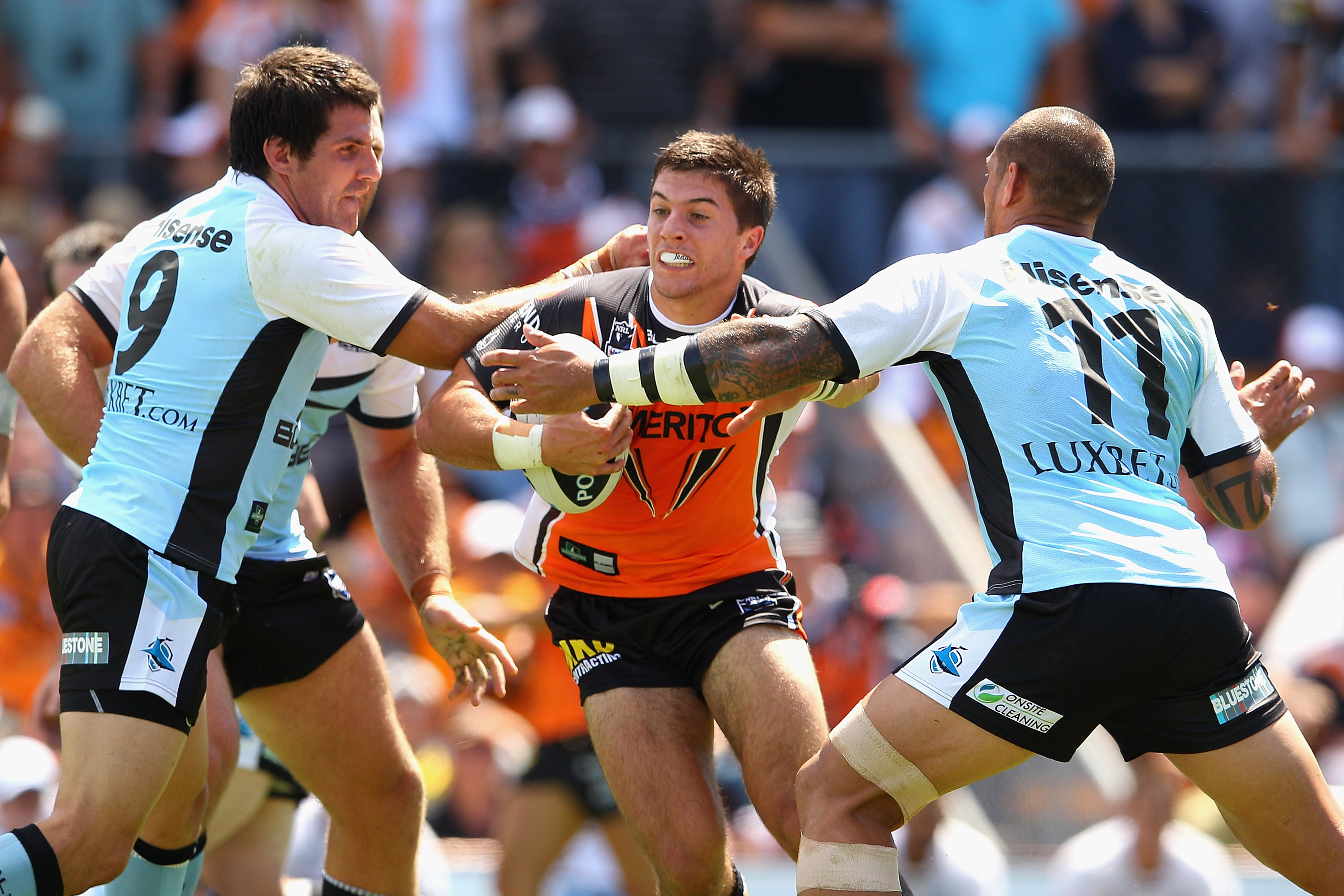 A man runs the ball during a rugby league match 